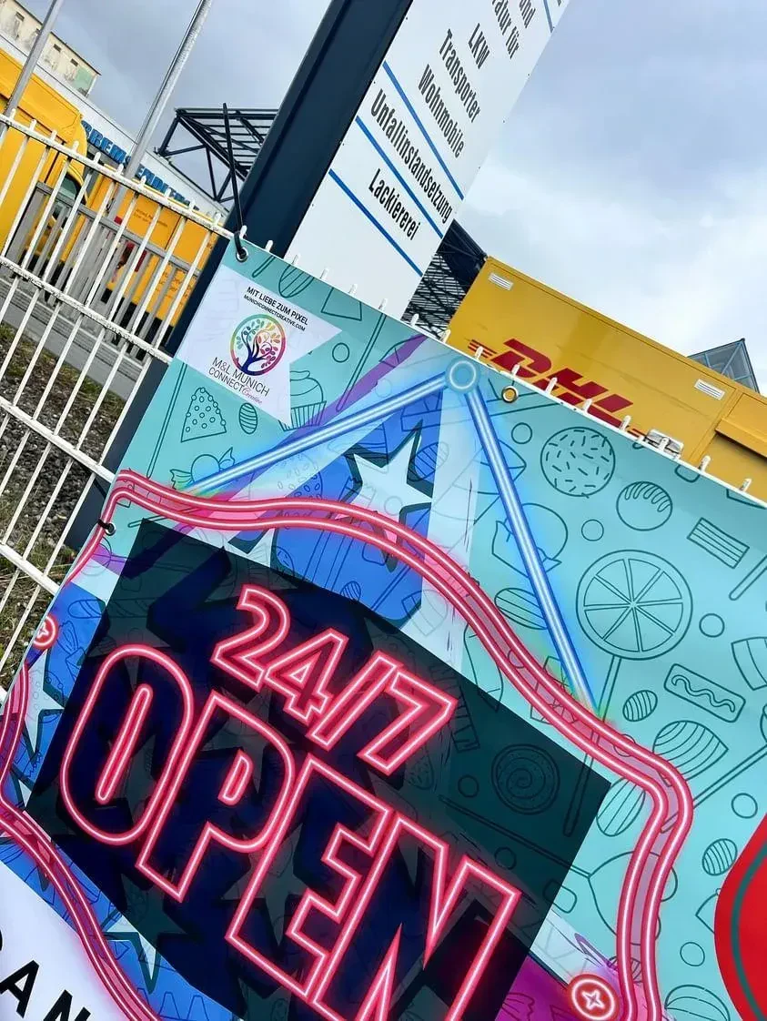 Gedrucktes Banner vor Ort mit „24/7 Open“-Schriftzug